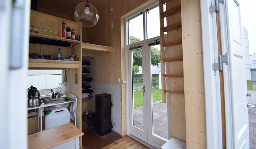 Une porte-vitrée rend la tiny house très lumineuse.