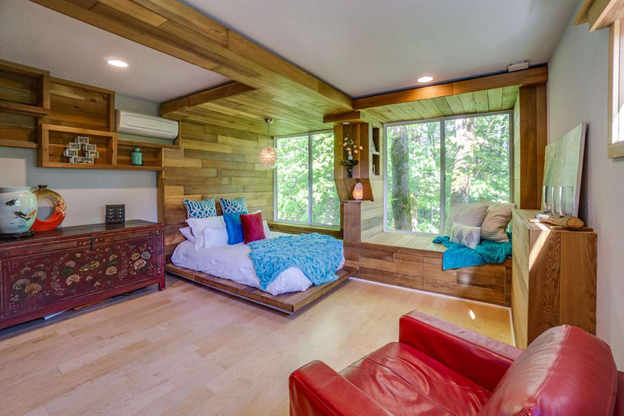 Une chambre en bois avec vue sur des arbres